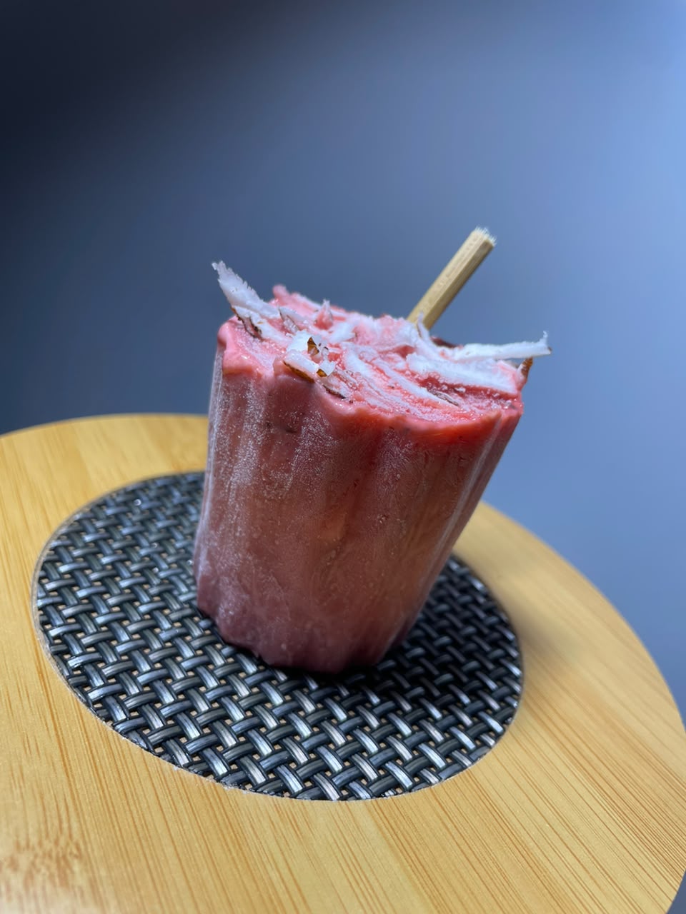 Strawberry Abele ice pop topped with coconut shavings
